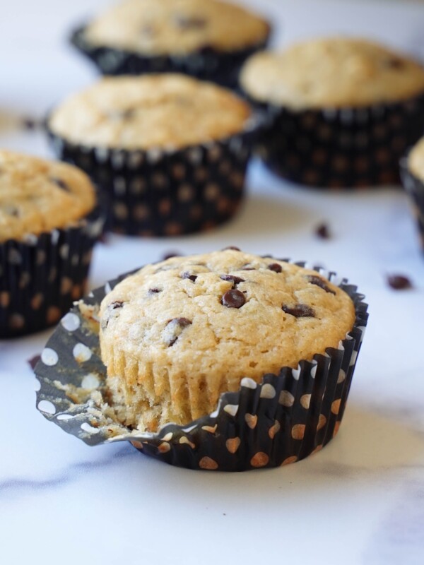 A banana sourdough discard muffin in a polka dot liner