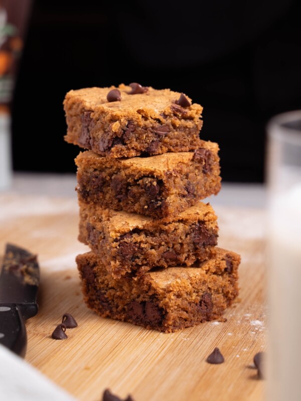 Brown butter blondies, stacked next to a glass of milk