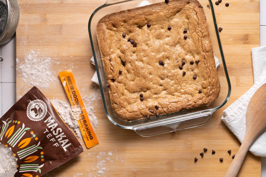 A pan of blondies next to a bag of teff flour