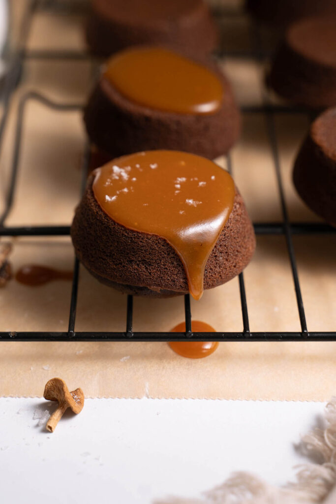 Mini chocolate cake with candy cap caramel dripping off the side