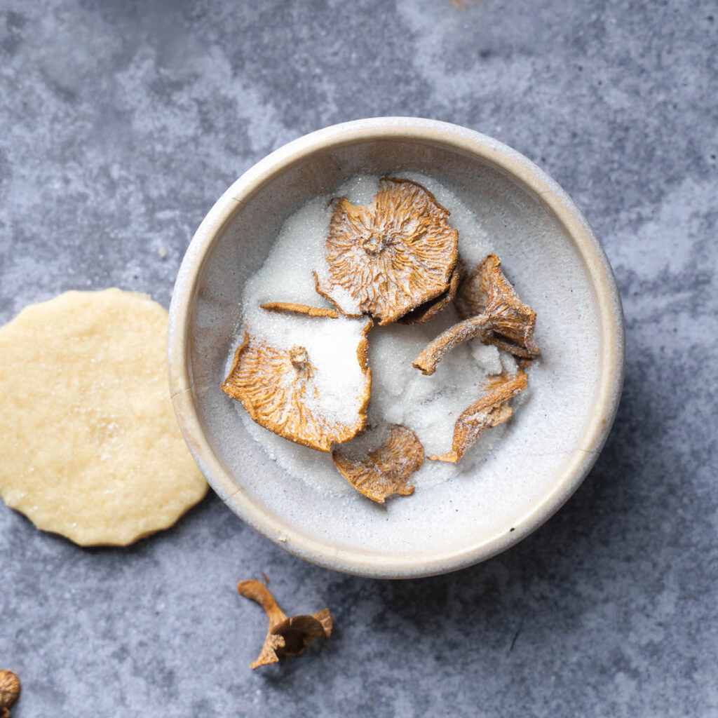 Candy cap mushrooms in a bowl of sugar