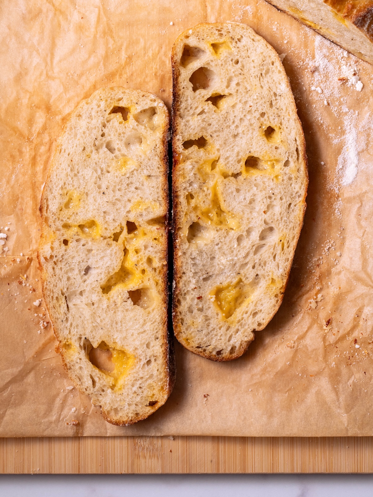 Slices of sourdough cheese bread with gooey pockets of melted cheese