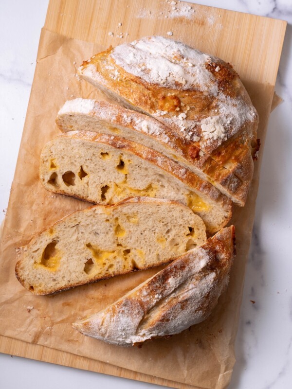 A loaf of homemade cheesy sourdough bread sliced