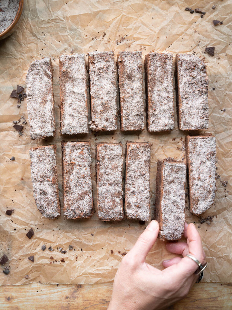 Hand grabbing a chocolate shortbread cookie