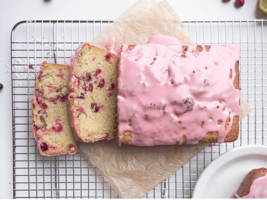 A cranberry almond loaf cake sliced open
