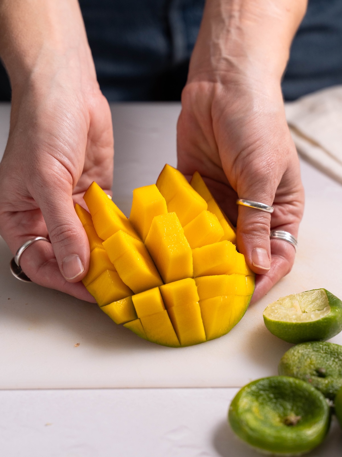 Fanning out pieces of mango, chopped from the skin