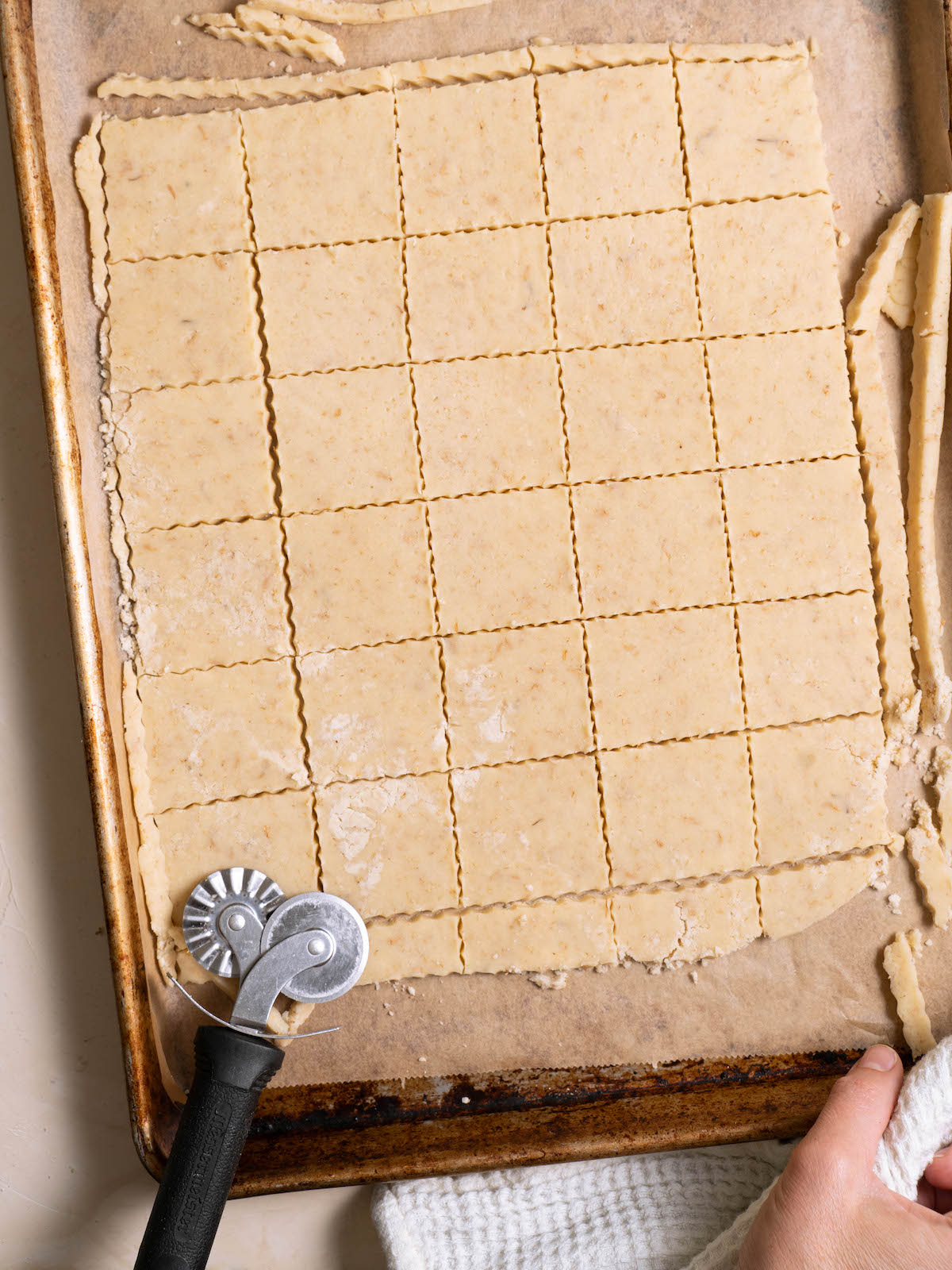 Cutting chamomile shortbread into squares with a pastry wheel