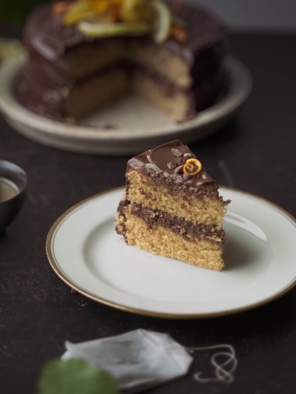 A slice of earl grey cake with chocolate frosting