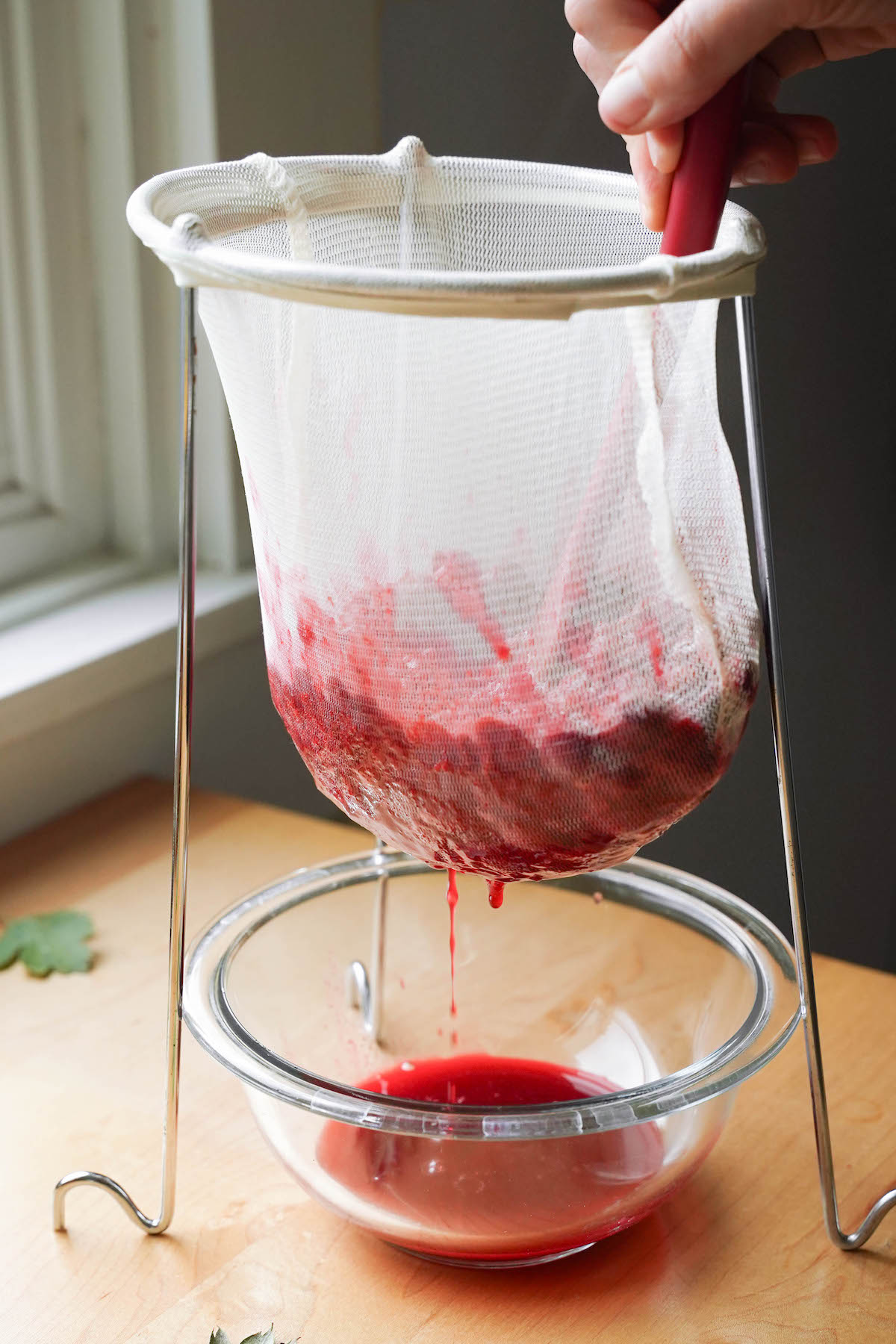 Straining hawthorn berries to extract their juice