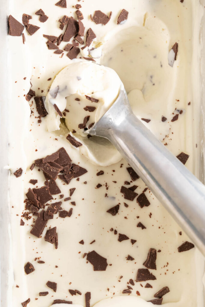 Scooping no-churn mint ice cream out of a pan