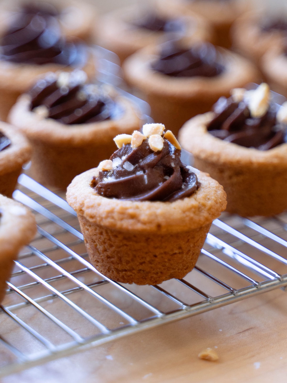 A peanut butter cookie cup filled with dark chocolate ganache