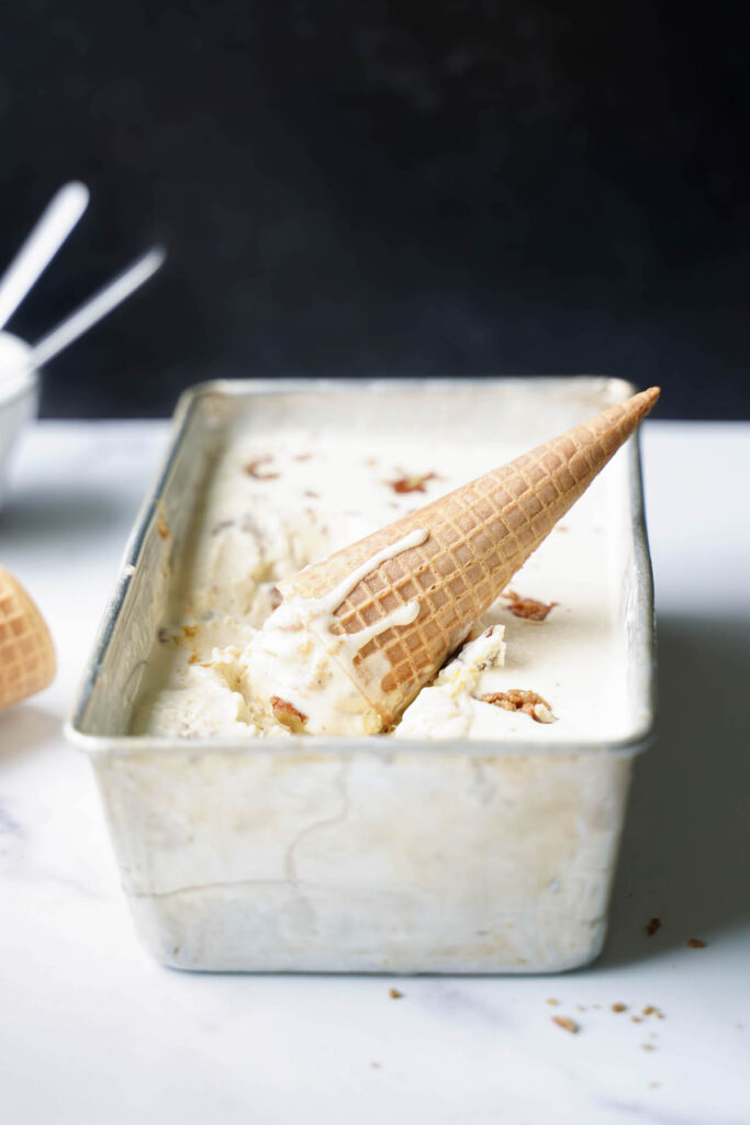 An ice cream cone melting into a pan of no-churn ice cream