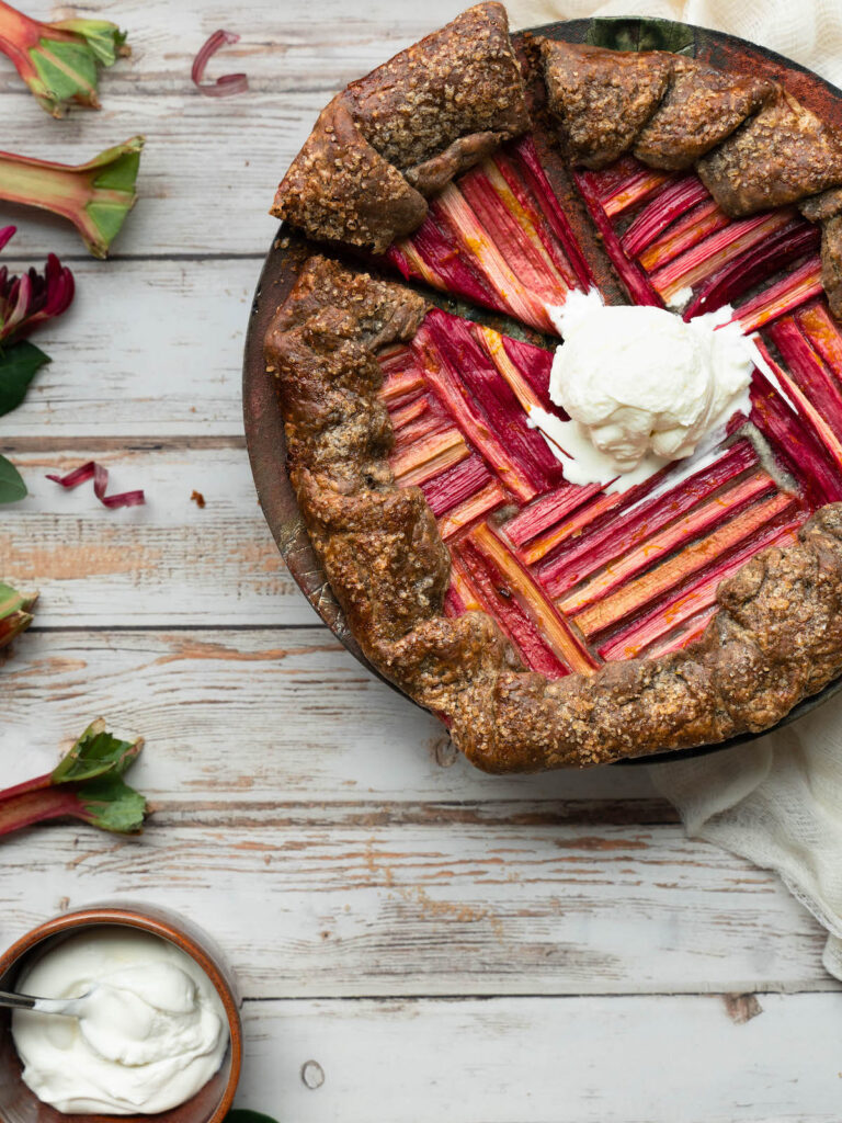 A rhubarb galette with whipped cream on top