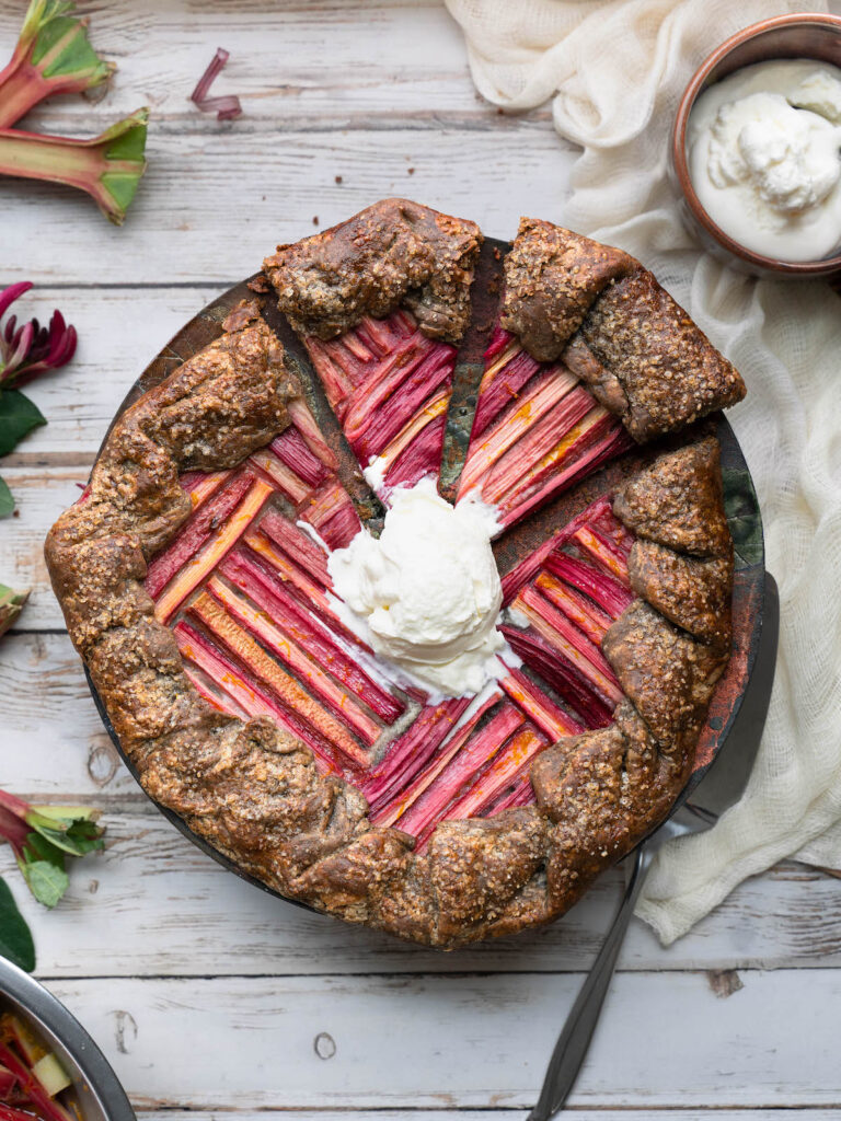 Rhubarb galette with buckwheat crust, topped with vanilla whipped cream