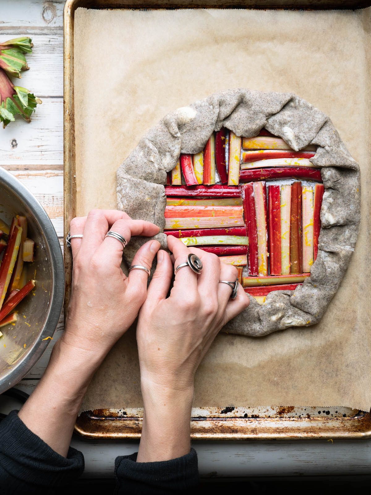 Crimping the edges on a rhubarb tart before baking