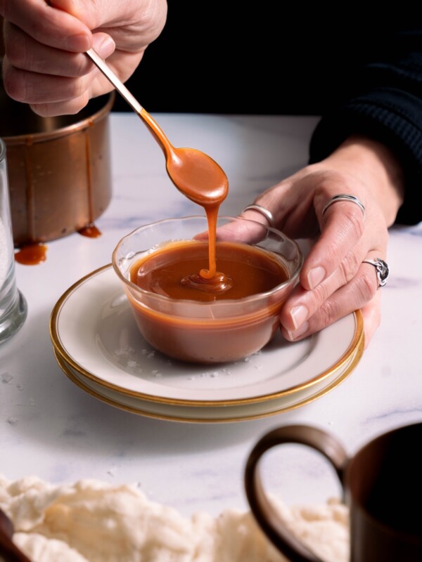 Salted caramel sauce dripping off a spoon