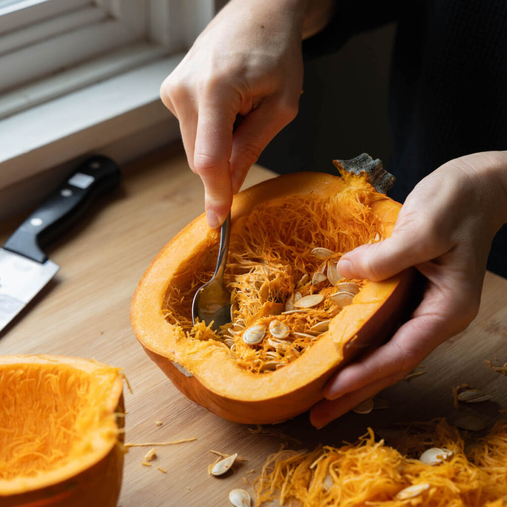 Scooping seeds out of a pumpkin
