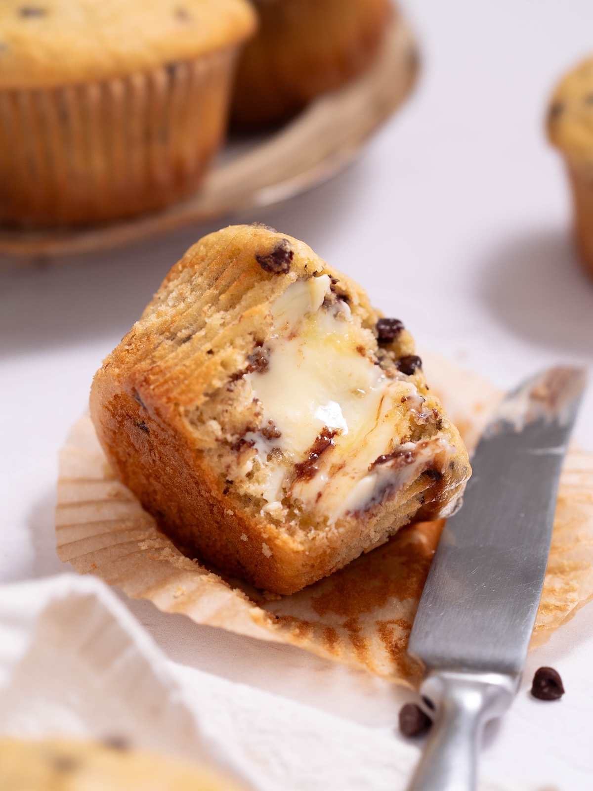 A fresh muffin, cut open and smeared with melty butter