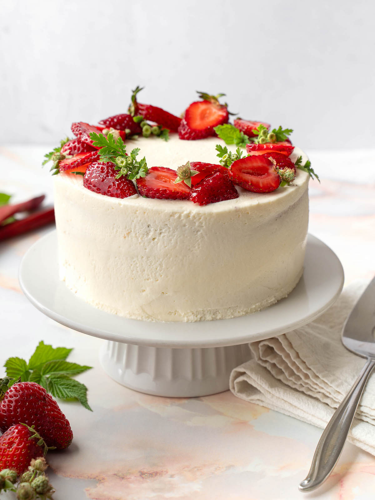 A layer caked decorated with fresh strawberries