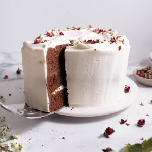 A slice being taken out of a chocolate rose cake