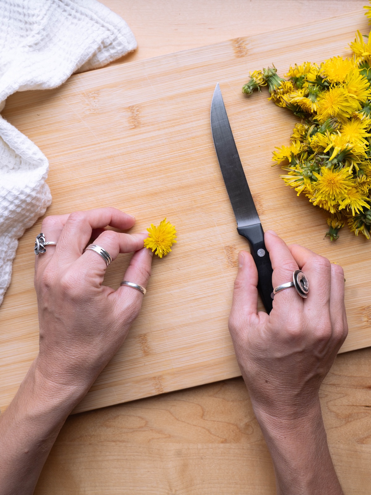 Fresh dandelion flowers on a cutting board