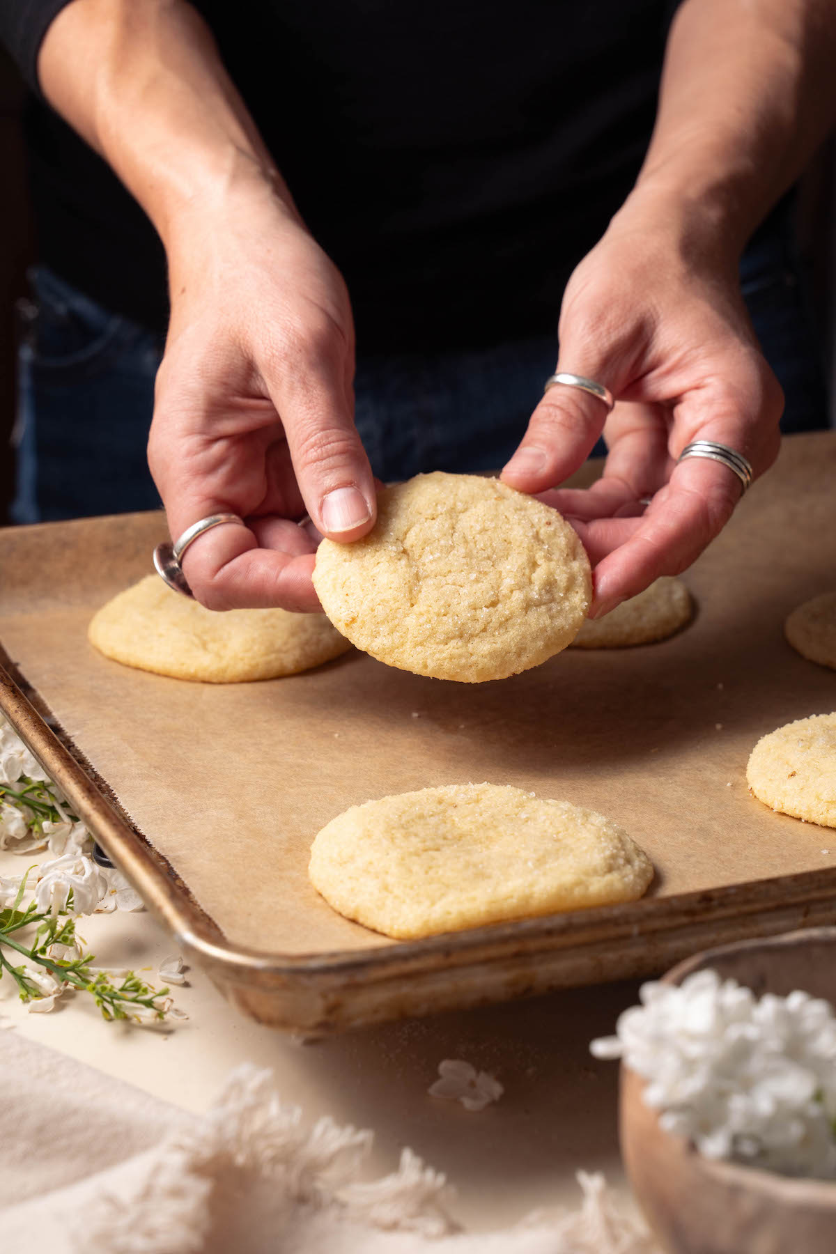Hands holding a lilac snickerdoodle to show texture