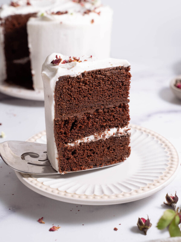 A slice of chocolate rose cake being plated