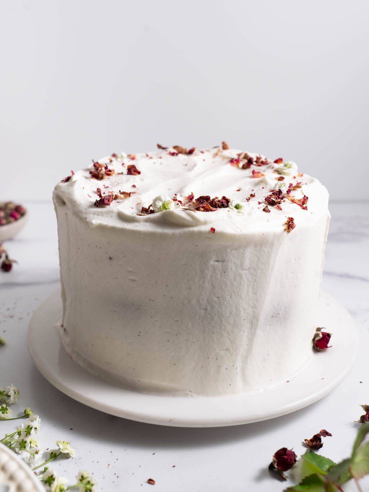 A whole chocolate rose cake frosted with vanilla whipped cream