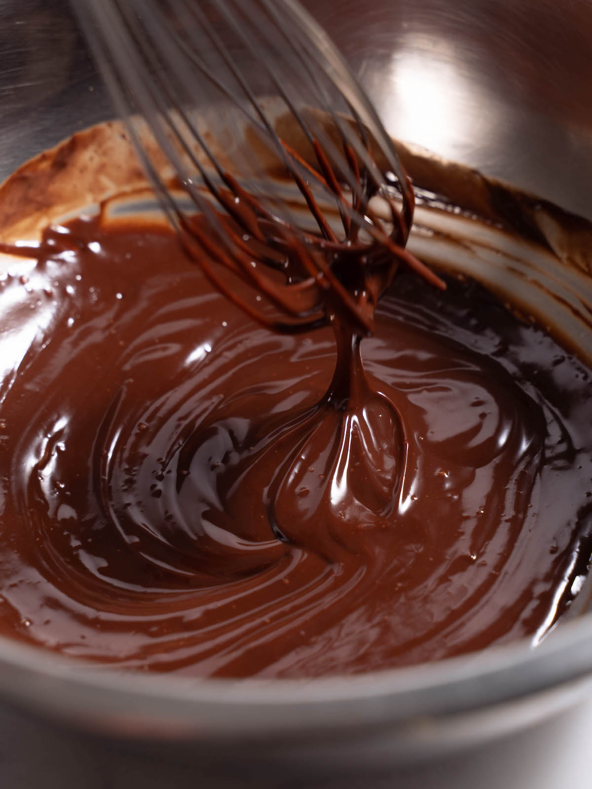 Up close silky texture of chocolate rose ganache
