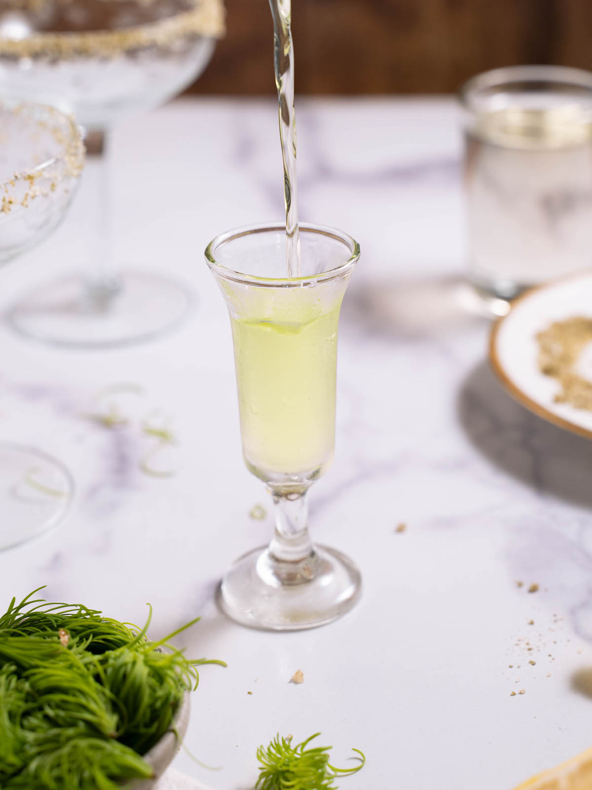 Pouring fir tip vodka into a shot glass