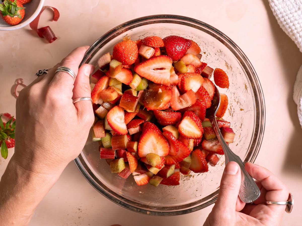 Stirring fruit together with sugar and flavorings