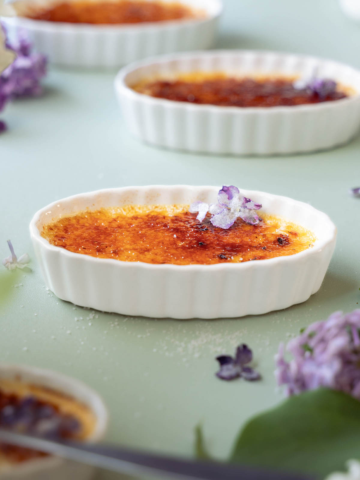 Lilac crème brûlées freshly caramelized