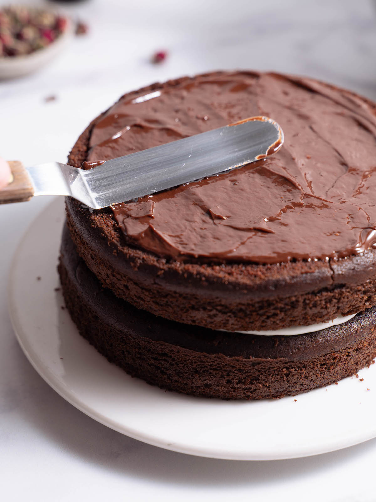 Spreading ganache onto a cake layer