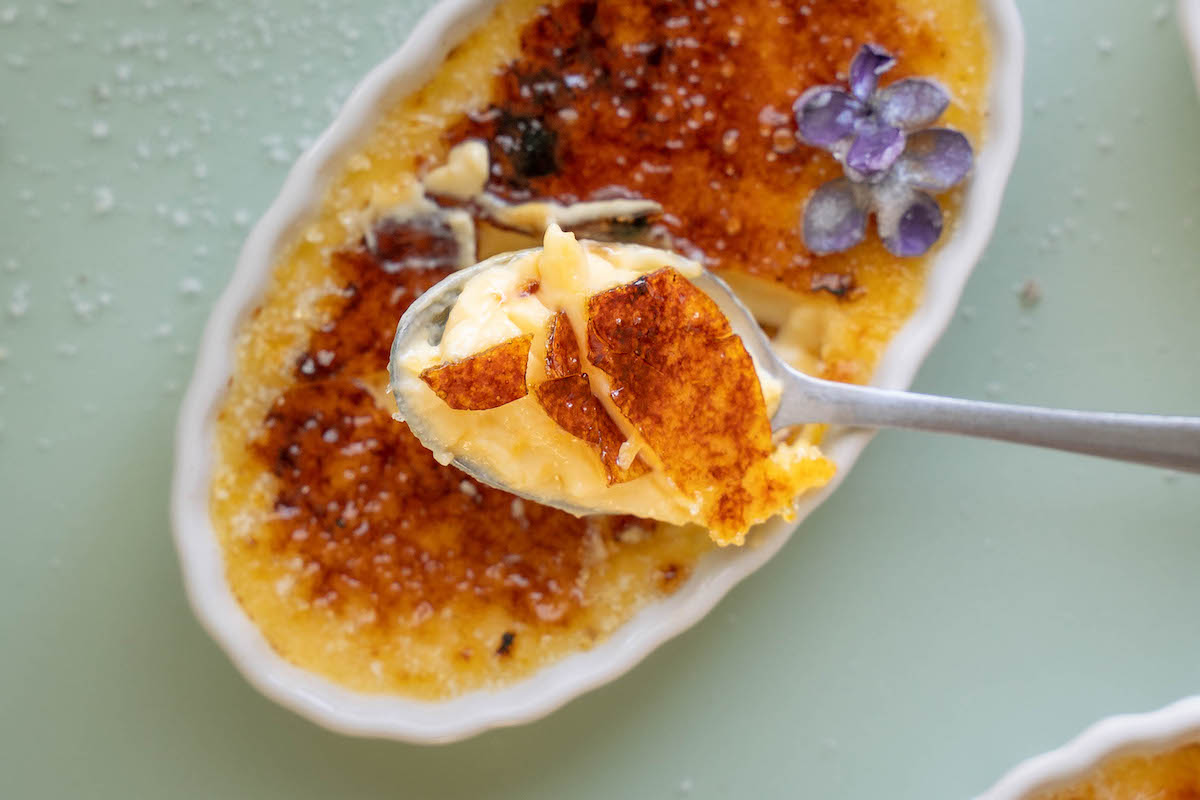 A closeup of a bite of crème brûlée