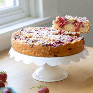 A slice being removed from a balsamic strawberry cake