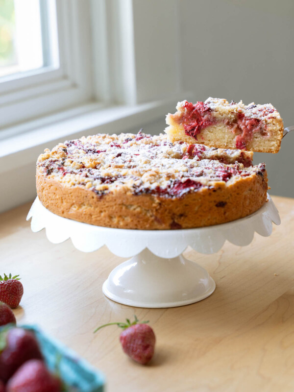 A slice being removed from a balsamic strawberry cake