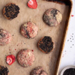 Strawberry black sesame cookies on a baking sheet