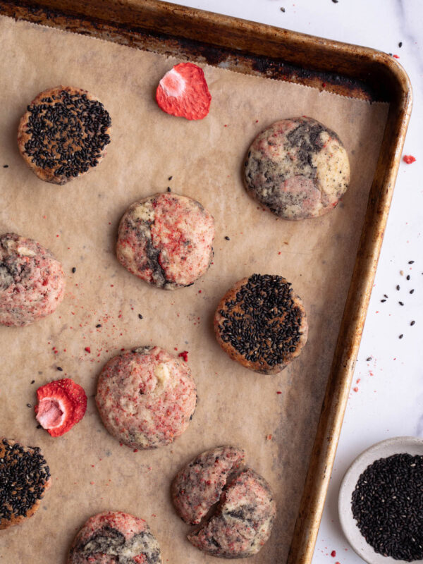 Strawberry black sesame cookies on a baking sheet