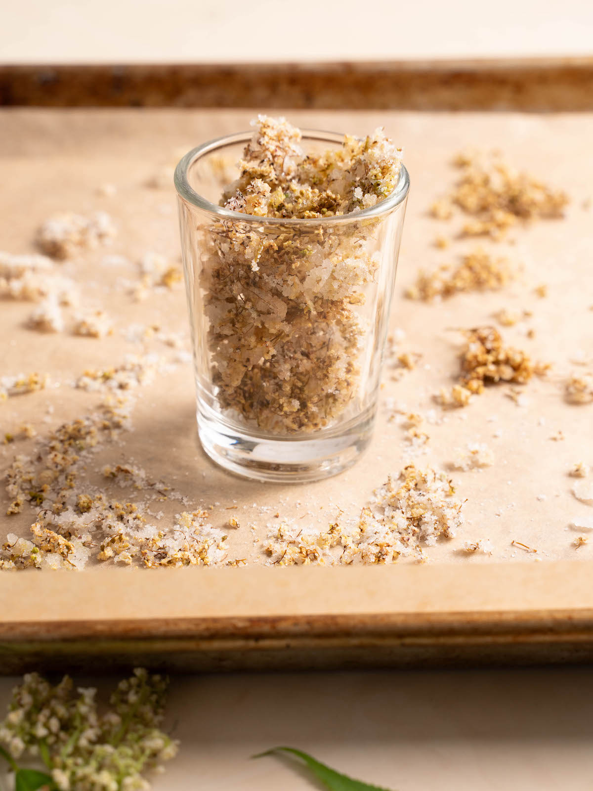 Dried candied elderflowers in a glass