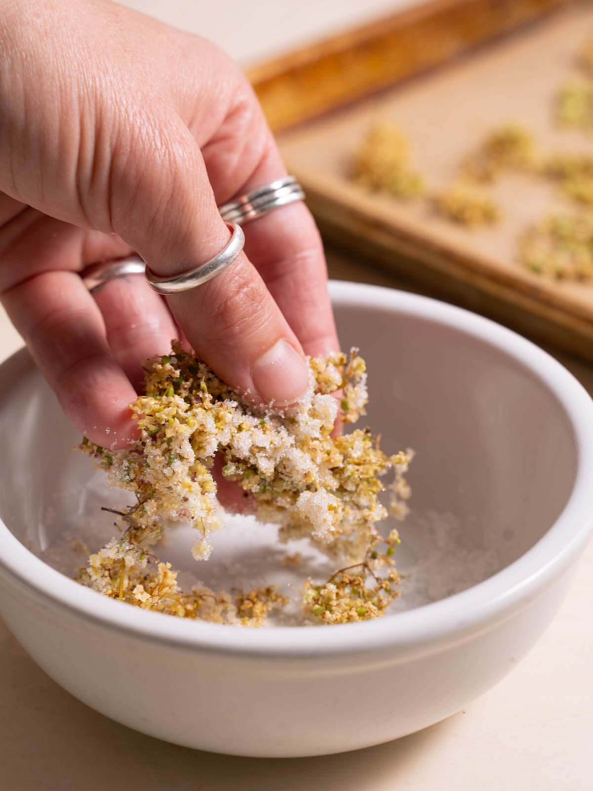 Dipping flowers into sugar to candy them