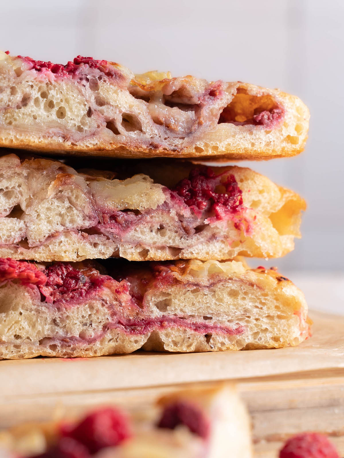 Up close view of bread to show layers of brie and raspberry jam