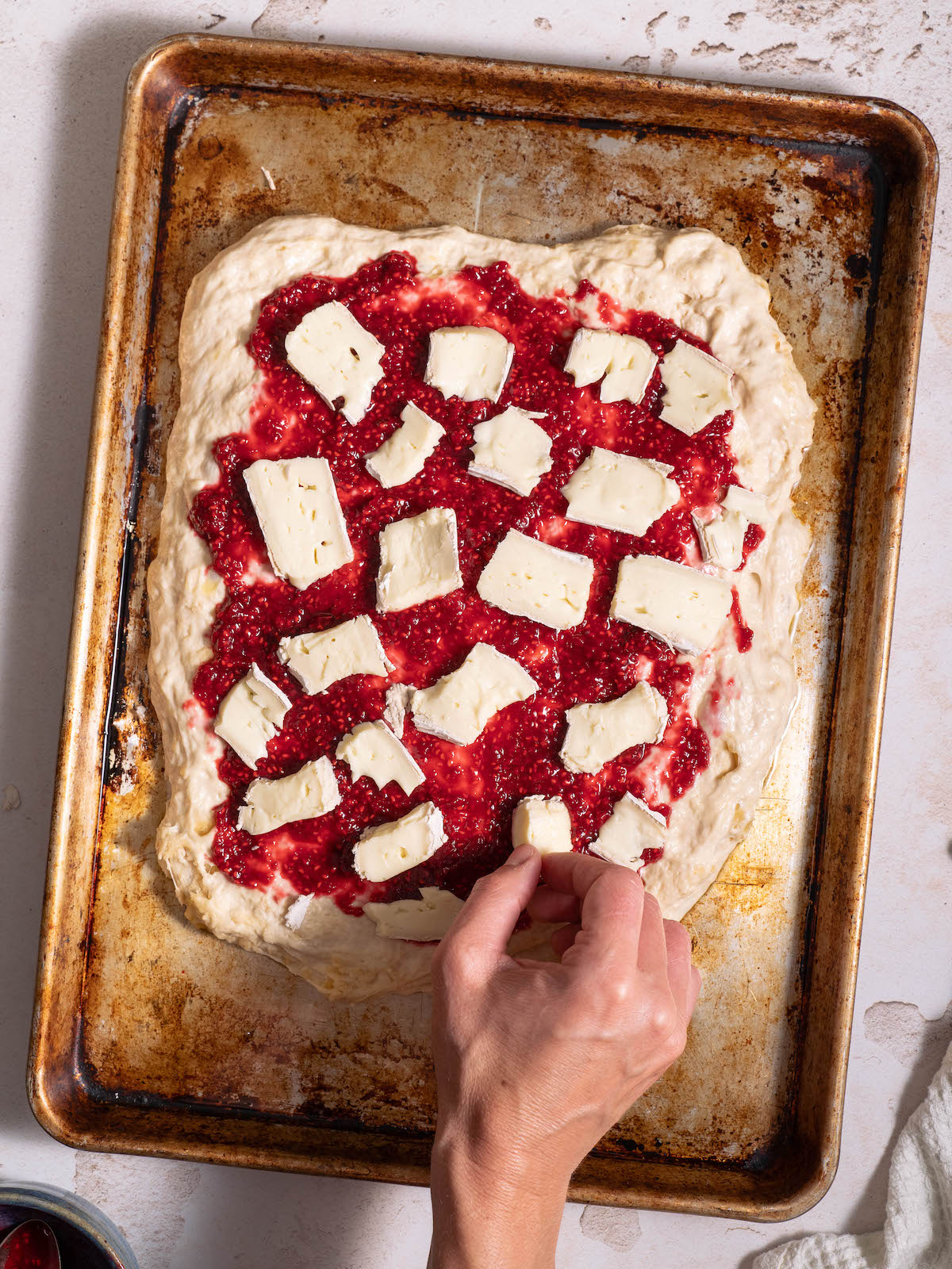 Adding brie to focaccia bread