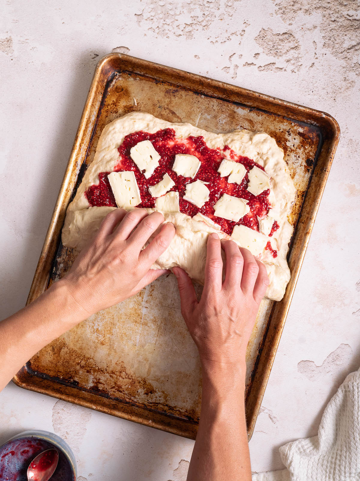 Rolling stuffed focaccia into a log