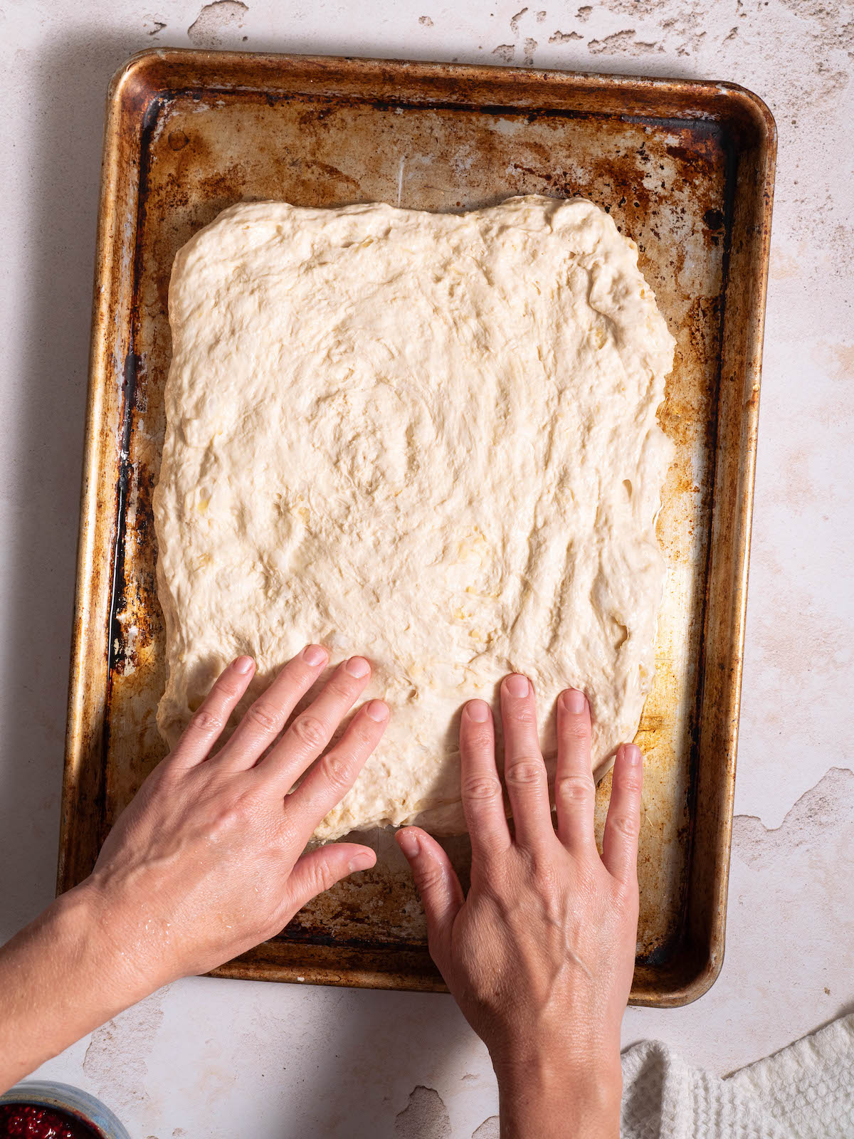 Stretching focaccia dough into a rectangle