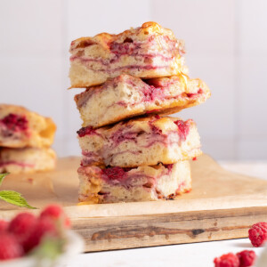 Squares of raspberry brie focaccia bread stacked on top of each other
