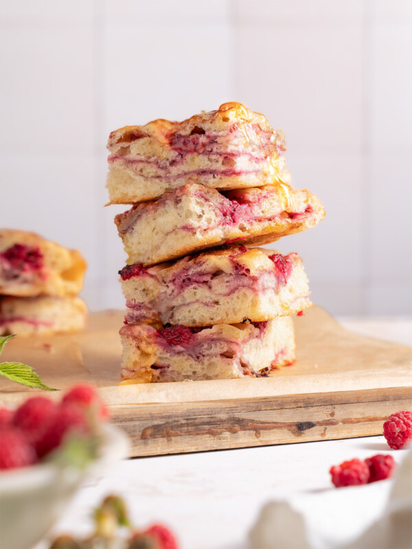 Squares of raspberry brie focaccia bread stacked on top of each other