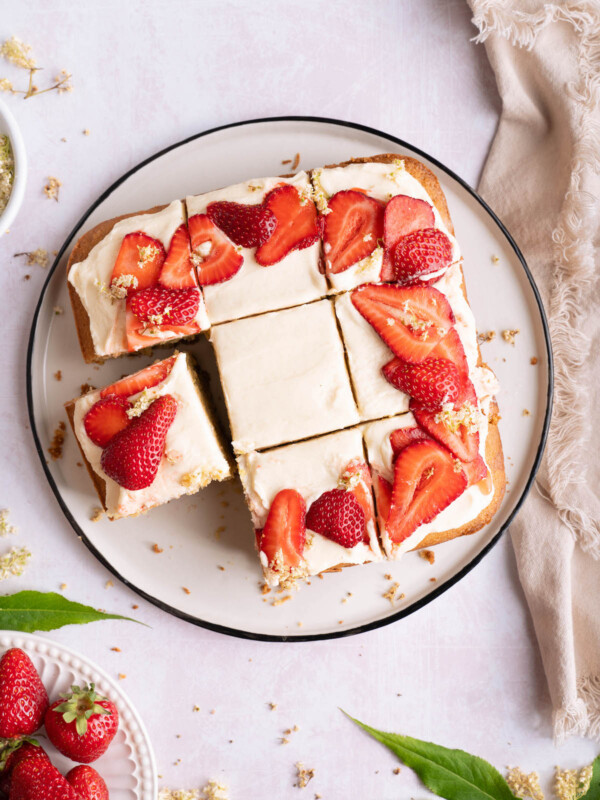 Strawberry elderflower cake cut into pieces
