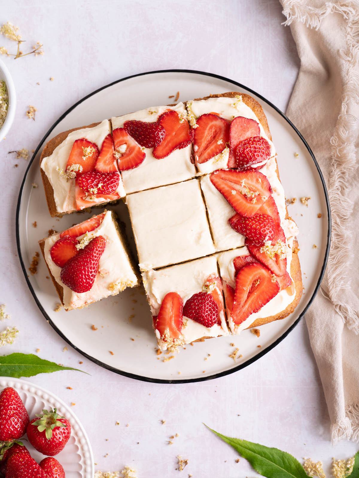 Strawberry elderflower cake cut into pieces