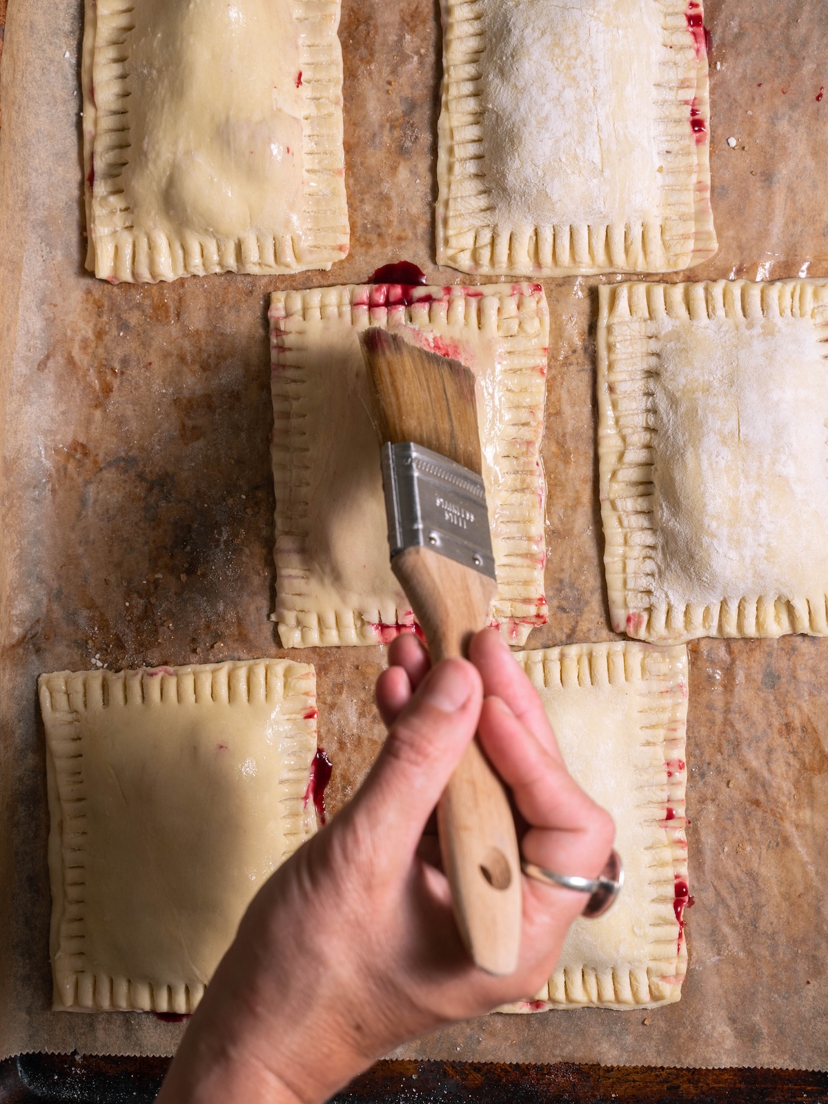 Brushing hand pies with egg wash