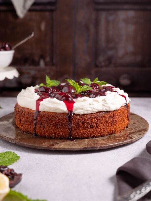 A one-layer ricotta cake topped with stewed cherries and crème fraîche